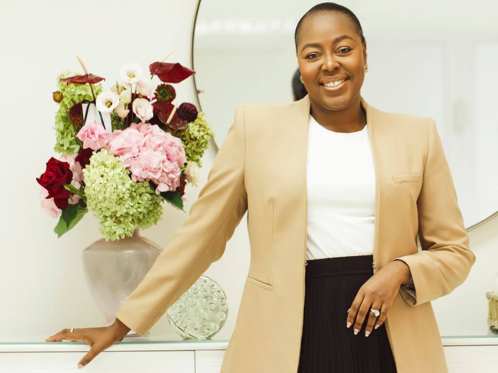 Dr Nokubonga Khoza standing in her clinic, specialising in menopause skin changes and care.